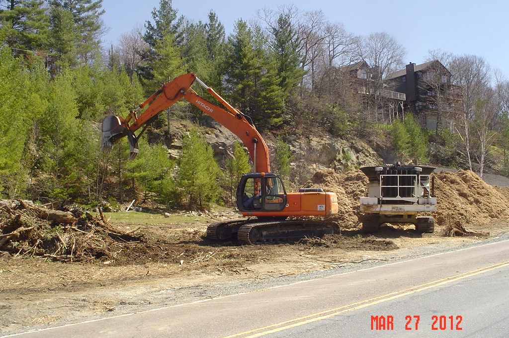 Stump grinding machine cutting a tree stump into chips